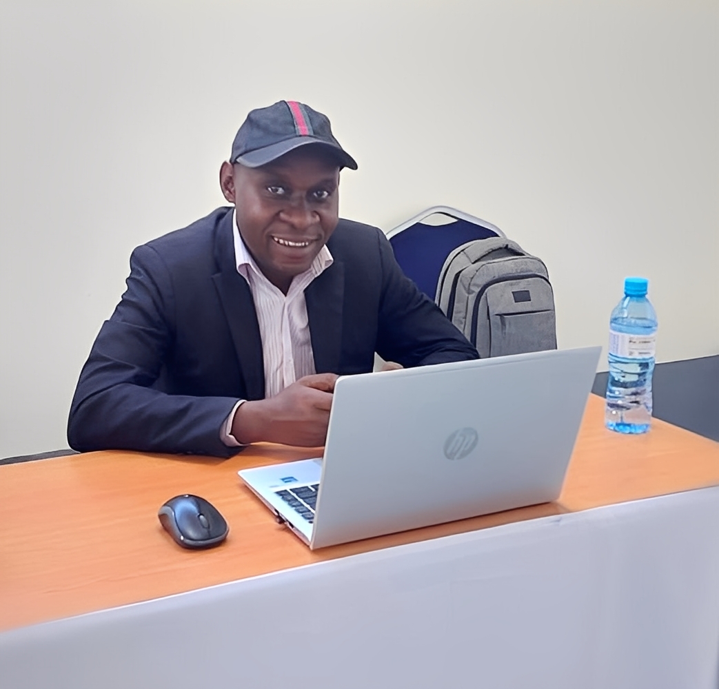 Augusto Mate smiling in front of a laptop